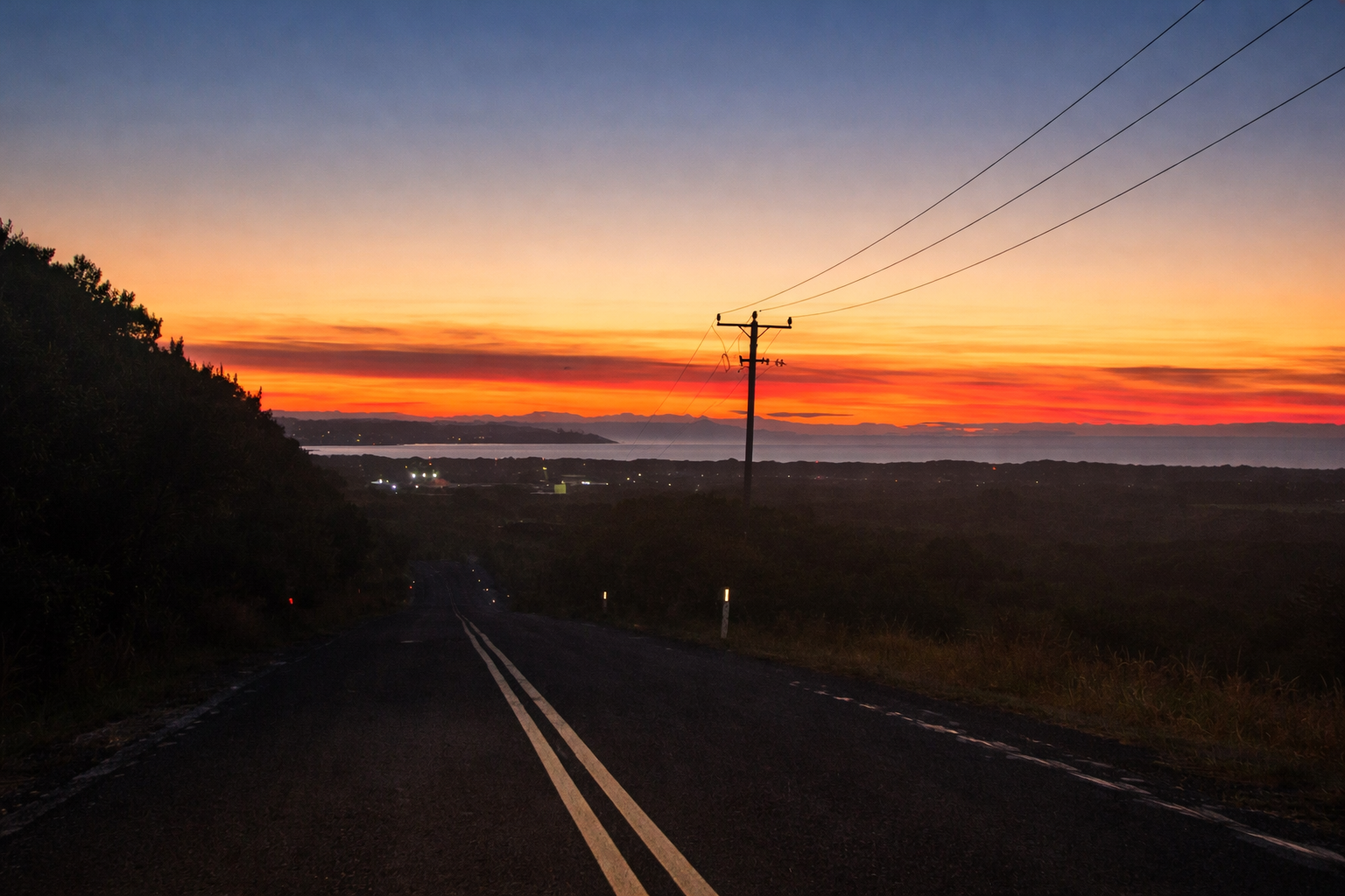 Rural Tasmanian road at dusk, a high risk time for wildlife vehicle collisions.