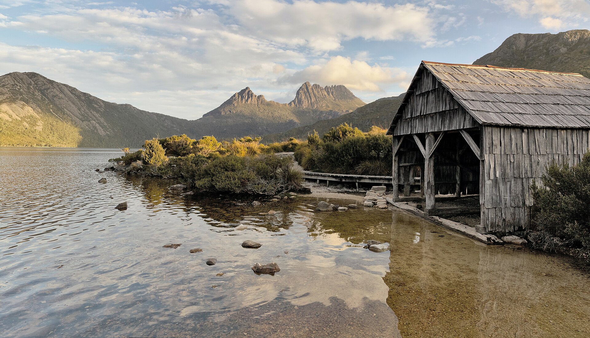Wooden boatshed beside Dove Lake with Cradle Mountain in the background, Tasmania